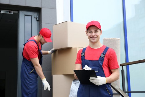 Removal team carefully handling packed household items during a move