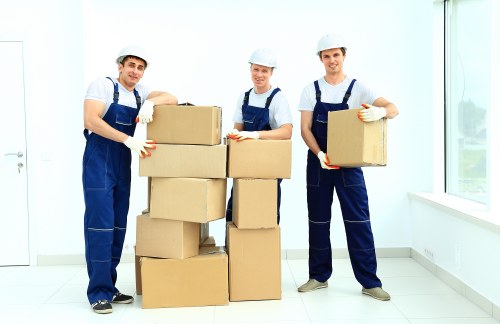 Removal team carrying furniture near a Fulham apartment building