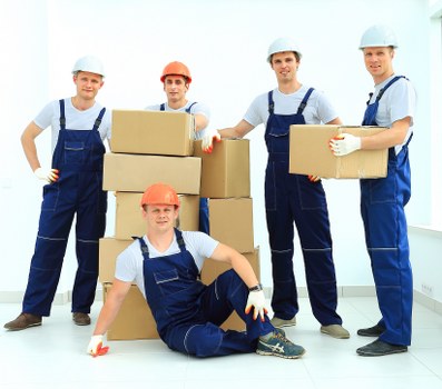 Removal team handling household items during a booked move