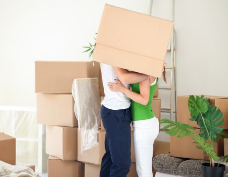 Professional removals crew loading furniture securely into a van