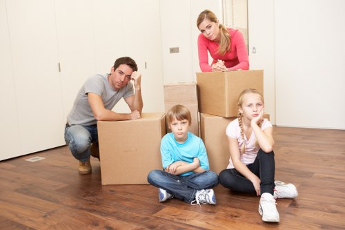 Professional moving team handling packed boxes and furniture